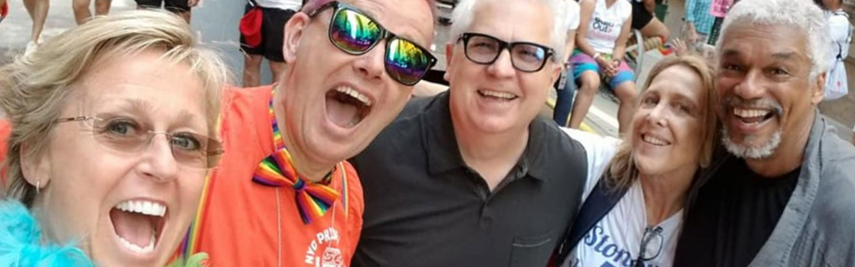 People celebrate together at a Pride Month parade