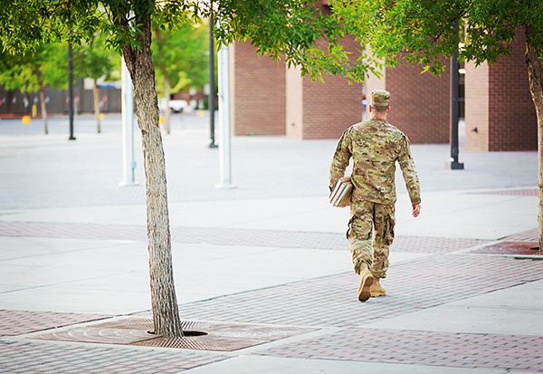 Man in military uniform on a college campus
