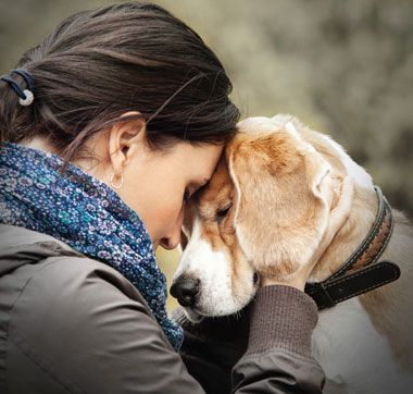 Pet owner embracing her dog