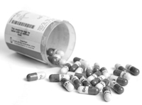Spilled bottle of drug capsules