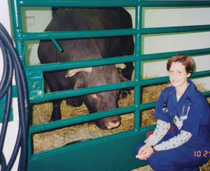 Dr. Hale in front of bull stall gate