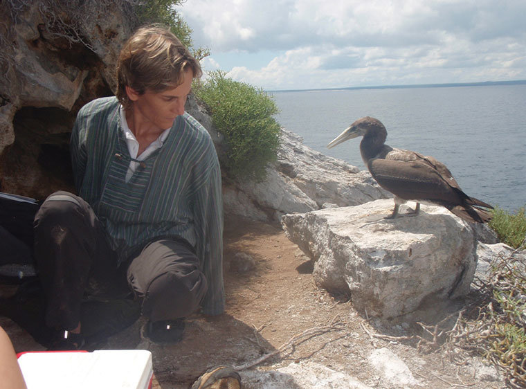 Dr. Sharon L. Deem in the field observing a bird